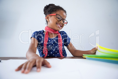 Smiling girl as businesswoman looking at files