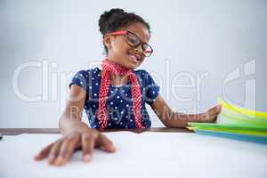 Smiling girl as businesswoman looking at files