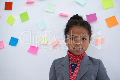 Portrait of businesswoman standing  against sticky notes on wall