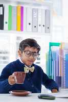 Businessman having coffee at desk