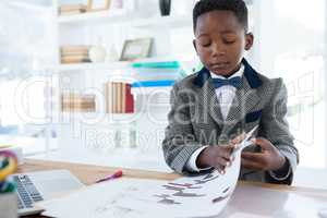 Confident businessman reading document at desk