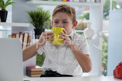 Businessman drinking coffee from yellow mug