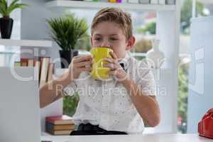 Businessman drinking coffee from yellow mug