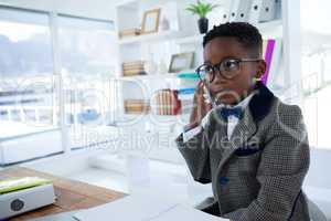 Thoughtful businessman talking on mobile phone