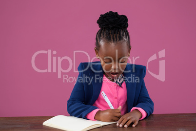 Serious businesswoman making reports at desk