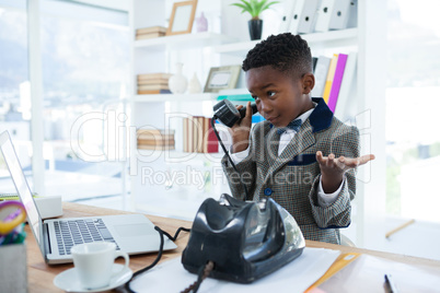 Businessman shrugging while talking on telephone