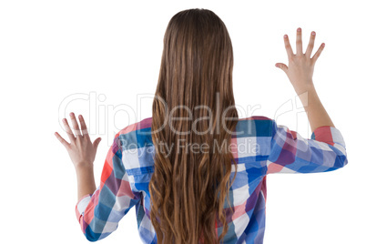 Girl pressing an invisible virtual screen against white background