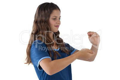 Smiling girl with hand cupped against white background