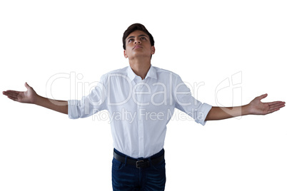Teenage boy standing with hands raised