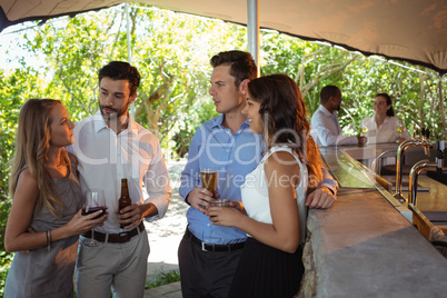 Friends having a alcohol at counter