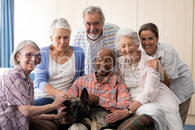 Portrait of cheerful senior people and practitioner with dog