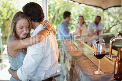 Couple embracing each other at counter