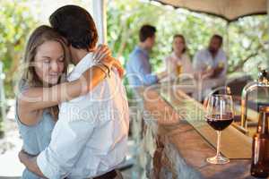 Couple embracing each other at counter