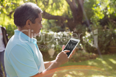 Senior man using digital tablet