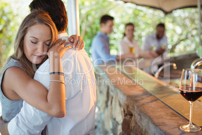 Couple embracing each other at counter