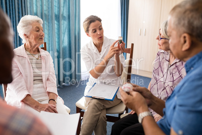 Female doctor explaining medicine to seniors