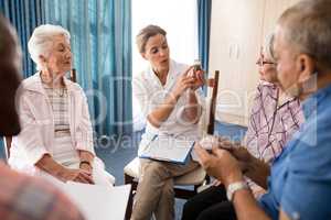 Female doctor explaining medicine to seniors