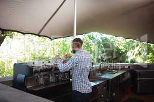 Waiter preparing coffee at outdoor cafÃ?Â©