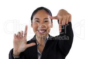 Close up portrait of smiling businesswoman doing finger frame gesture