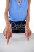 Mid section of young businesswoman gesturing on table