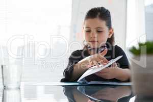 Girl imitating as businesswoman reading file