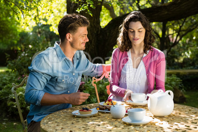 Couple having breakfast in garden