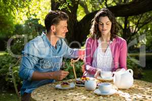 Couple having breakfast in garden