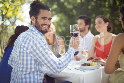 Man holding a wine glass in restaurant