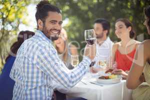 Man holding a wine glass in restaurant