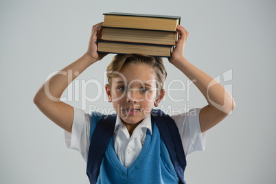 Schoolboy holding her book on her head