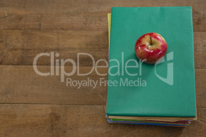 Red apple on book stack