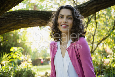 Woman sitting on bench in garden