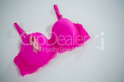 High angle view of Breast Cancer Awareness ribbon on pink bra