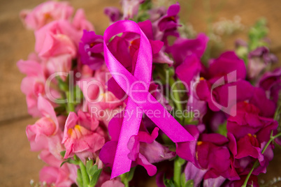 Close-up of pink Breast Cancer Awareness ribbon on flowers