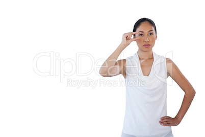 Businesswoman looking away while adjusting invisible eyeglasses