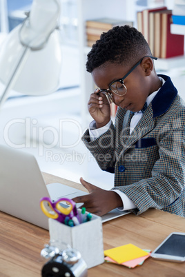 Businessman using laptop at desk