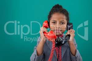 Portrait of businesswoman talking land line phones