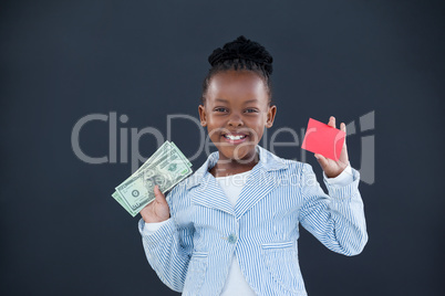 Portrait of smiling businesswoman holding currency and red card