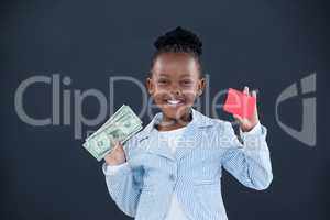 Portrait of smiling businesswoman holding currency and red card