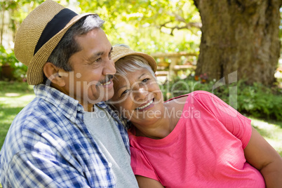 Senior couple having a glass of wine in garden