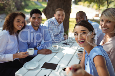 Group of friends sitting together in outdoor restaurant
