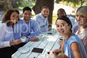 Group of friends sitting together in outdoor restaurant