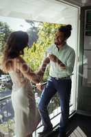 Couple interacting with each other while having champagne