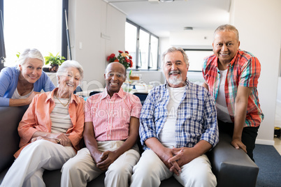 Portrait of multi-ethnic senior people sitting on couch