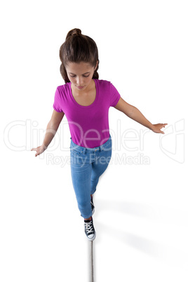 Girl walking on a tight rope and trying to keep her balance