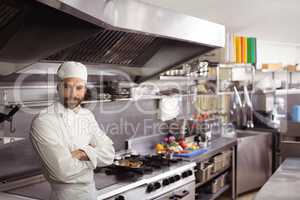 Thoughtful chef standing in commercial kitchen