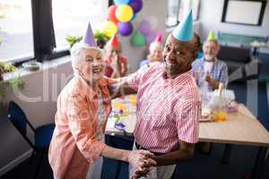 Portrait of happy senior couple dancing at party