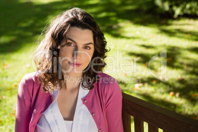 Woman sitting on bench in garden