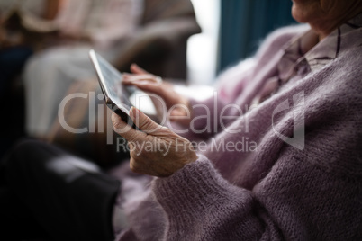 Midsection senior woman using digital tablet