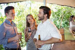 Friends interacting while having a alcohol at counter